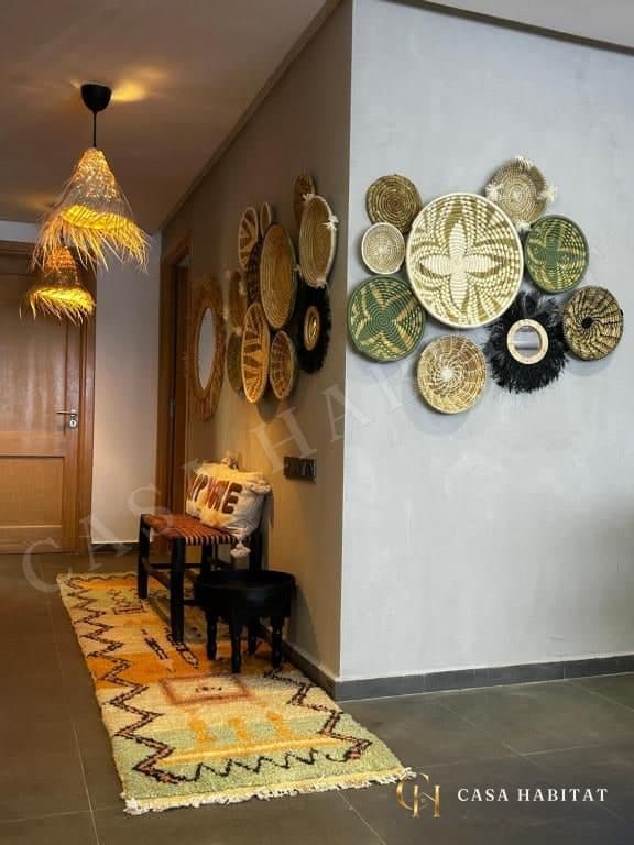 Couloir avec tapis, banc et paniers muraux en osier