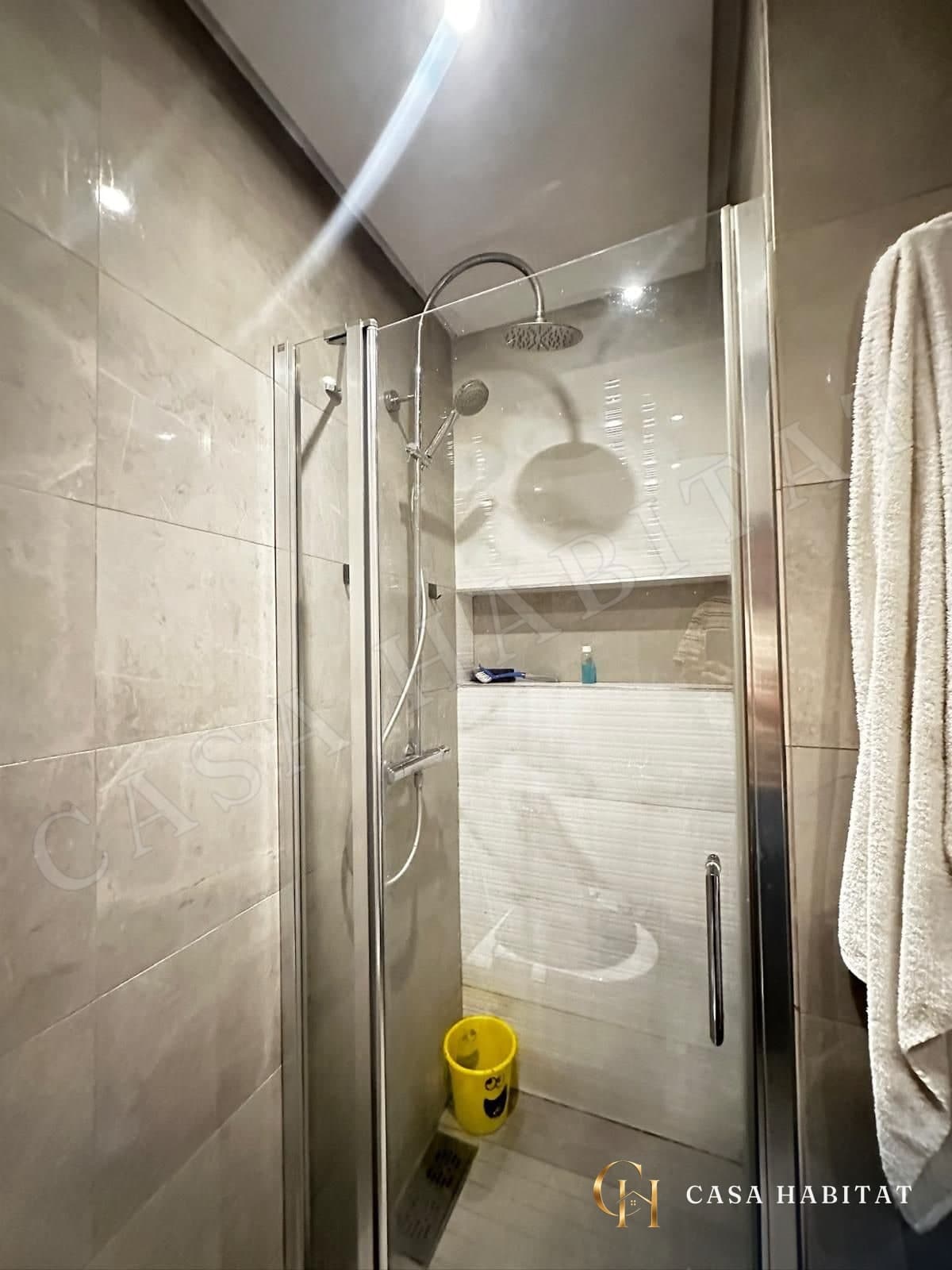 Douche en verre avec pommeau et niche murale