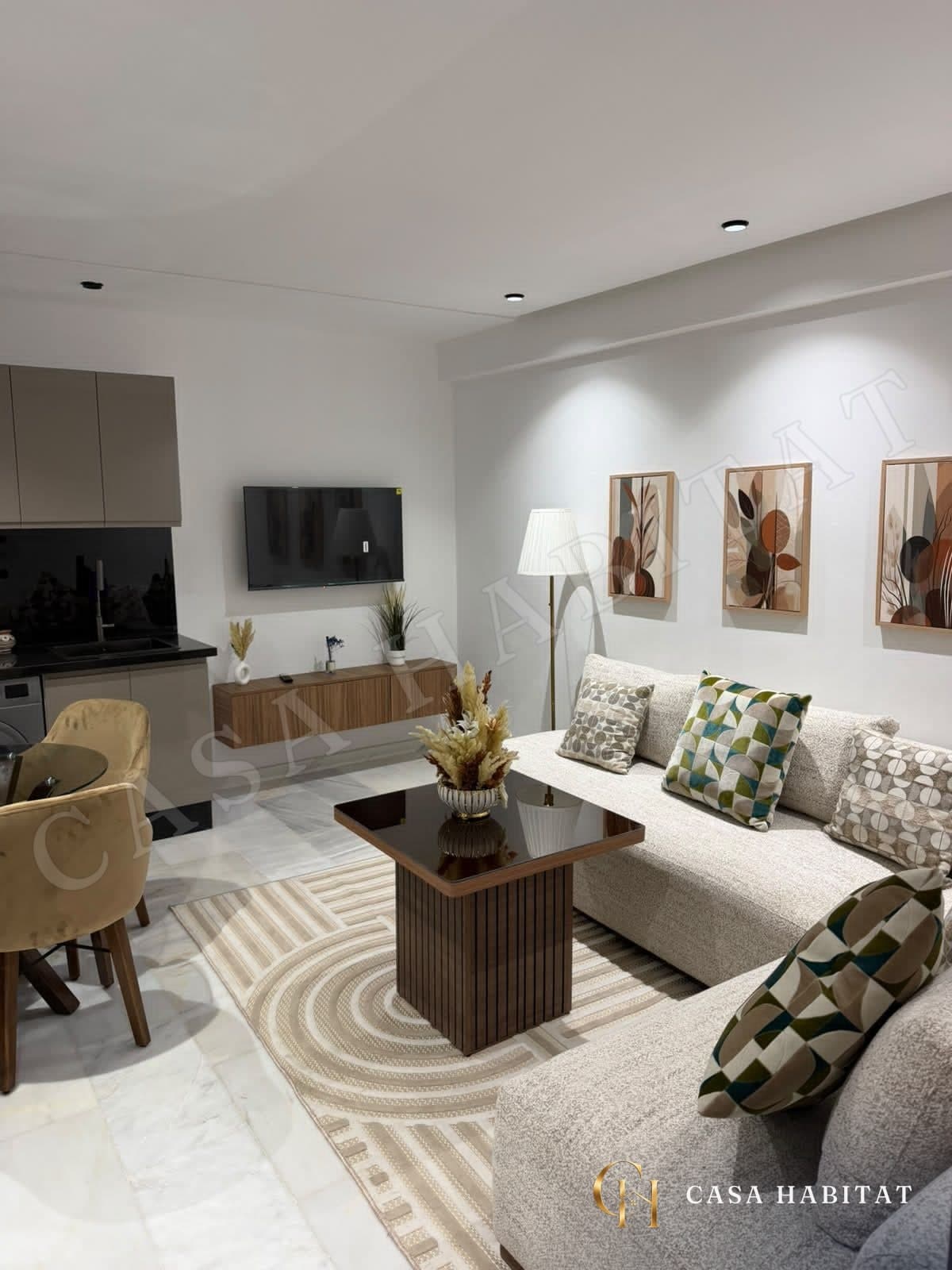 Living room with beige sofa, wooden coffee table, and striped rug